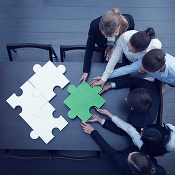 Business People solving Jigsaw